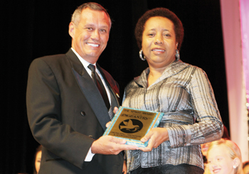 Pageantry CEO and IJM judge Carl Dunn was beckoned to the stage to present the Pageantry Spirit Award to Johnie Hamilton