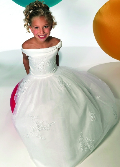 Model wearing a children's gown by Jacquelin Bridals